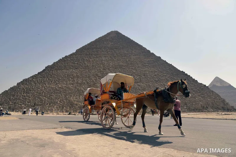 Egyptians ride horse carts on the third day of Eid al-Adha or the feast of sacrifice, in front of the Giza pyramids, in Cairo on September 03, 2017. Muslims around the world are celebrating Eid al-Adha, the "Feast of Sac...