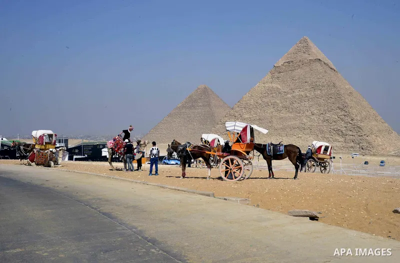 Egyptians celebrate on the third day of Eid al-Adha or the feast of sacrifice, in front of the Giza pyramids, in Cairo on September 03, 2017. Muslims around the world are celebrating Eid al-Adha, the "Feast of Sacrifice"...