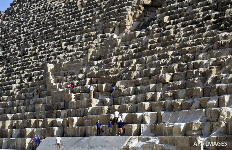 Egyptians celebrate on the third day of Eid al-Adha or the feast of sacrifice, in front of the Giza pyramids, in Cairo on September 03, 2017. Muslims around the world are celebrating Eid al-Adha, the "Feast of Sacrifice"...