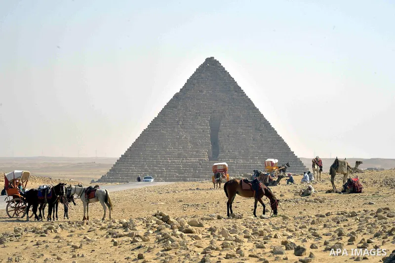 Egyptians celebrate on the third day of Eid al-Adha or the feast of sacrifice, in front of the Giza pyramids, in Cairo on September 03, 2017. Muslims around the world are celebrating Eid al-Adha, the "Feast of Sacrifice"...