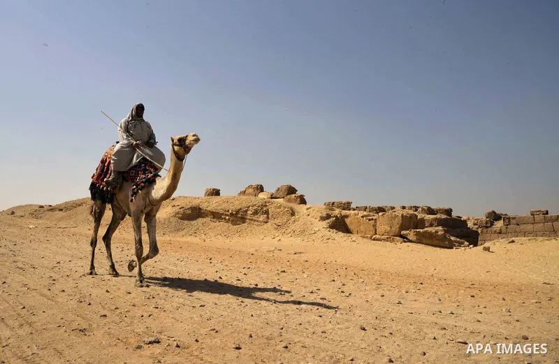 An Egyptian man rides a camel on the third day of Eid al-Adha or the feast of sacrifice, in front of the Giza pyramids, in Cairo on September 03, 2017. Muslims around the world are celebrating Eid al-Adha, the "Feast of...