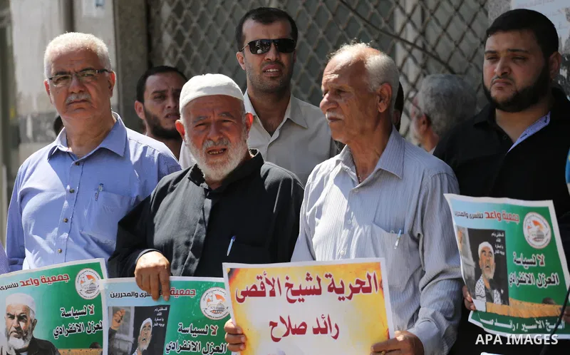 Palestinians hold banners during a protest to show solidarity with Leader of the northern Islamic Movement Sheikh Raed Salah who is held in Israeli jails in Gaza city, on Sept. 6, 2017. Photo by Mohammed Asad