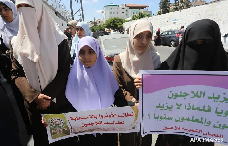 Members of the Joint Commission for Refugees hold banners during a protest to demand their rights in Gaza city, on Sept. 6, 2017. Photo by Mohammed Asad
