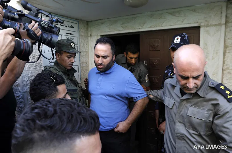 Palestinian security forces escorts Palestinian Activist Issa Amro outside a court in the West Bank city of Hebron, 07 September 2017. Issa Amro, the head of Youth Against settlements, faces charges after he wrote a post...