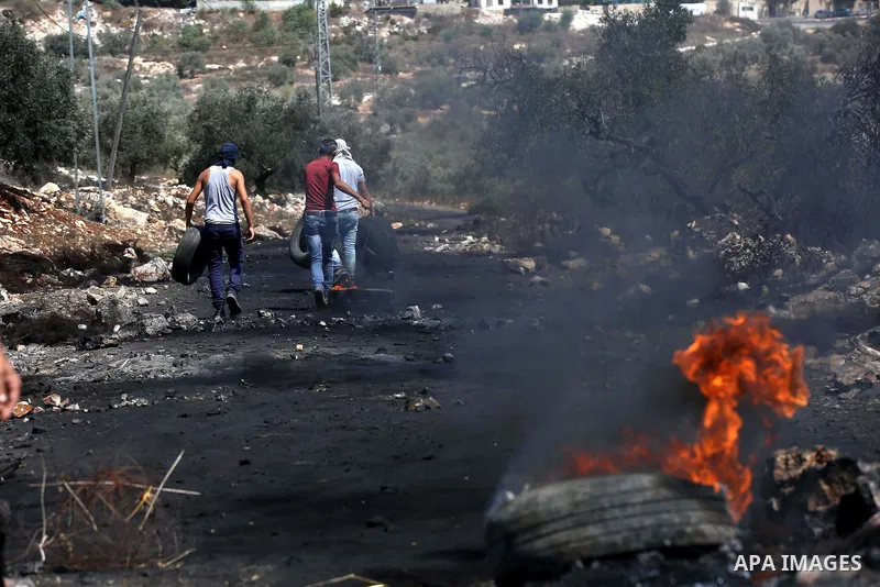 Palestinian protesters burn tires during clashes with Israeli troops near the Jewish settlement of Qadomem, in the West Bank village of Kofr Qadom near Nablus September 8, 2017. Photo by Ayman Ameen