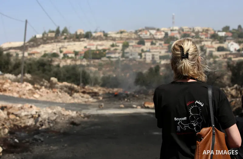 An Activist looks on during clashes with Israeli troops near the Jewish settlement of Qadomem, in the West Bank village of Kofr Qadom near Nablus September 8, 2017. Photo by Ayman Ameen