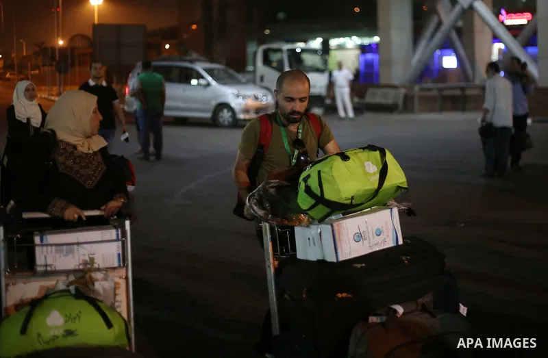 Palestinian pilgrims arrive to Cairo airport after performing the annual Hajj, in Cairo, Egypt, on September 9, 2017. Photo by Amr Sayed