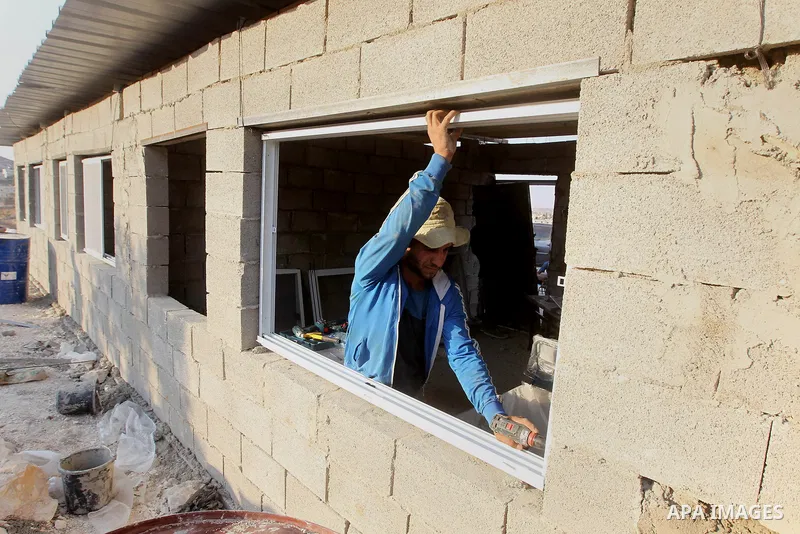 Palestinian construction laborers rebuilt a school after Israeli troops confiscated caravans used as school classrooms on August due to the lack of an Israeli-issued construction permit, in the West Bank village of Jubbe...