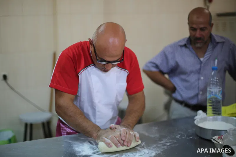 Italian and Palestinian chefs prepare traditional dishes from both of their countries during a workshop in Nuseirat in the center of Gaza strip, on September 11, 2017. Photo by Mohammed Asad