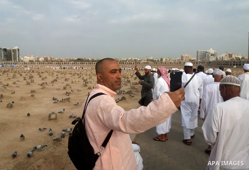 Muslim pilgrims visit Al-Baqi, the main cemetery for people are buried since the era of the Prophet Mohammad's family, relatives and companions, behind the Al-Masjid al-Nabawi, (the Mosque of the Prophet), after their du...
