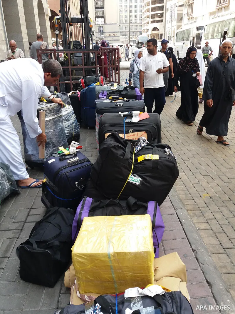 Muslim pilgrims load their bags after perform the annual hajj pilgrimage in the holy city of Mecca on Sept. 12, 2017. Photo by Mohammed Hassan