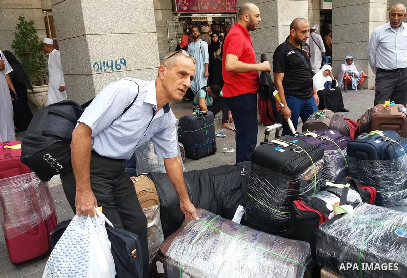 Muslim pilgrims load their bags after perform the annual hajj pilgrimage in the holy city of Mecca on Sept. 12, 2017. Photo by Mohammed Hassan