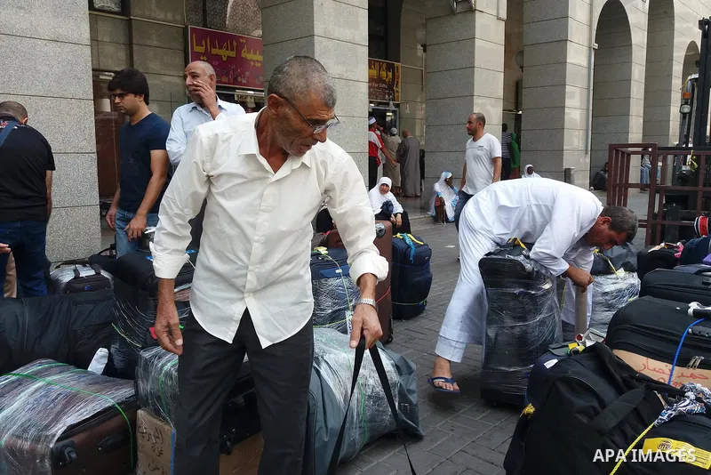 Muslim pilgrims load their bags after perform the annual hajj pilgrimage in the holy city of Mecca on Sept. 12, 2017. Photo by Mohammed Hassan