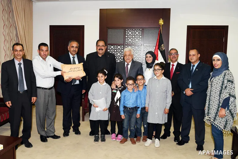 Palestinian President Mahmoud Abbas meets with the Minister of Education Sabri Sidem in the West Bank city of Ramallah on Sept. 12, 2017. Photo by Thaer Ganaim