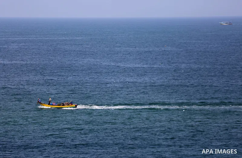 Palestinians ride their boat in the Mediterranean sea on the coast of Gaza city, on September 13, 2017. Photo by Mohammed Asad