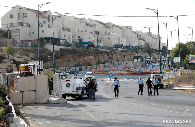 Israeli forensic policemen gather evidence at the site of a stabbing attack on the entrance of Jewish settlement of Kiryat Arba near the West Bank city of Hebron on Septemper 13, 2017. Israeli forces shot and wounded a 1...