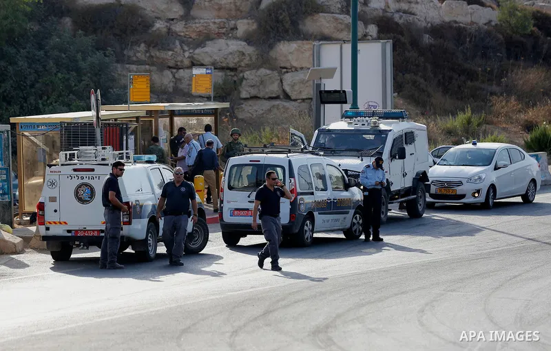 Israeli forensic policemen gather evidence at the site of a stabbing attack on the entrance of Jewish settlement of Kiryat Arba near the West Bank city of Hebron on Septemper 13, 2017. Israeli forces shot and wounded a 1...