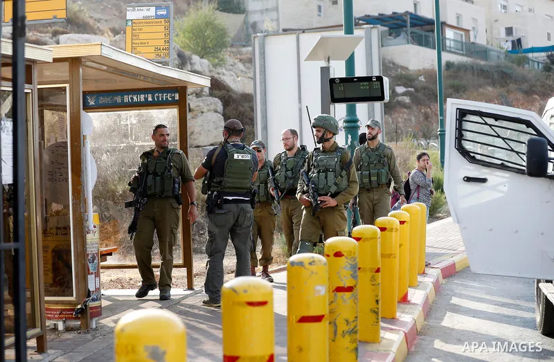 Israeli forensic policemen gather evidence at the site of a stabbing attack on the entrance of Jewish settlement of Kiryat Arba near the West Bank city of Hebron on Septemper 13, 2017. Israeli forces shot and wounded a 1...