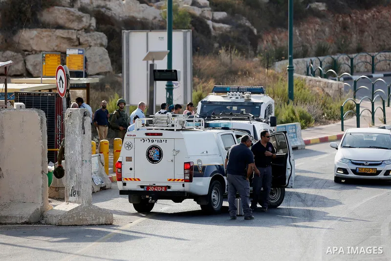 Israeli forensic policemen gather evidence at the site of a stabbing attack on the entrance of Jewish settlement of Kiryat Arba near the West Bank city of Hebron on Septemper 13, 2017. Israeli forces shot and wounded a 1...