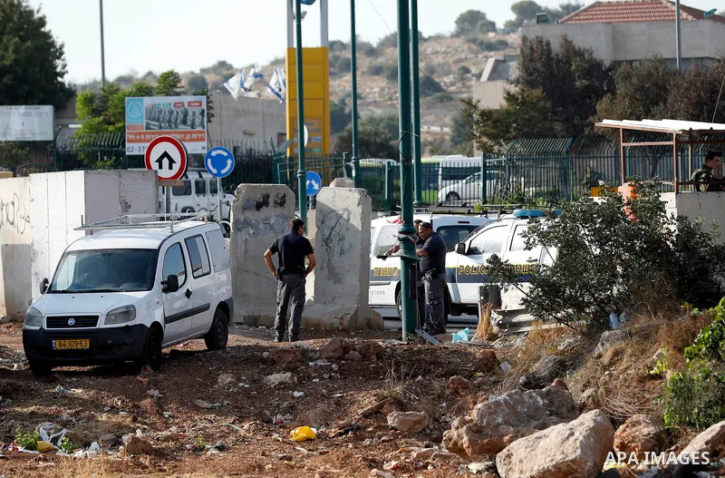 Israeli forensic policemen gather evidence at the site of a stabbing attack on the entrance of Jewish settlement of Kiryat Arba near the West Bank city of Hebron on Septemper 13, 2017. Israeli forces shot and wounded a 1...