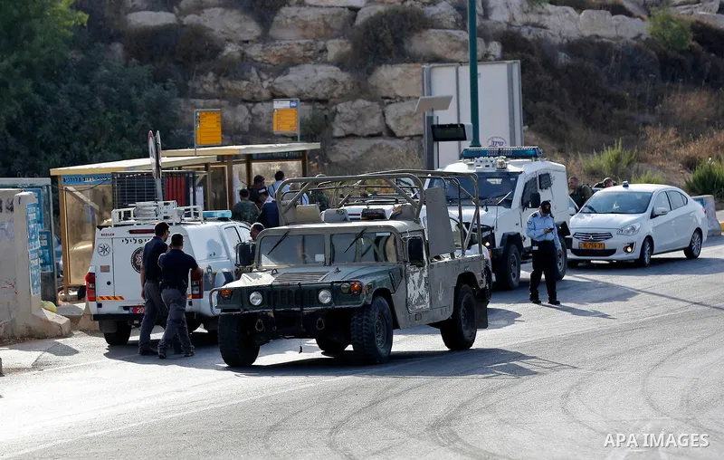 Israeli forensic policemen gather evidence at the site of a stabbing attack on the entrance of Jewish settlement of Kiryat Arba near the West Bank city of Hebron on Septemper 13, 2017. Israeli forces shot and wounded a 1...