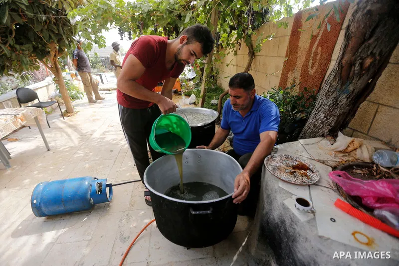 A Palestinian farmer prepares the grape juice at his field near the West Bank city of Hebron, Sept. 14, 2017. Hebron is famous for its quality grape production and its lush vineyards. Photo by Wisam Hashlamoun