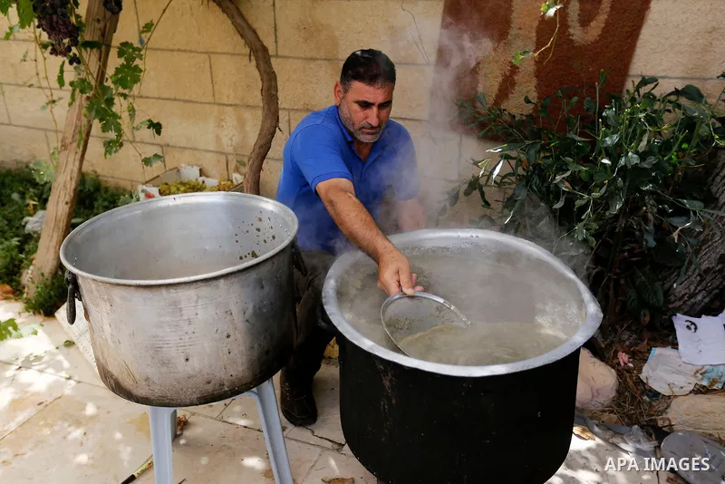 A Palestinian farmer prepares the grape juice at his field near the West Bank city of Hebron, Sept. 14, 2017. Hebron is famous for its quality grape production and its lush vineyards. Photo by Wisam Hashlamoun