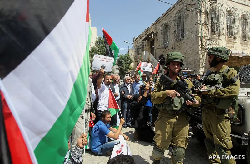 Palestinian protesters take part in a demonstration in the West Bank city of Hebron on September 15, 2017. Israel has given Jewish settlement enclaves in the occupied West Bank city of Hebron the authority to manage thei...