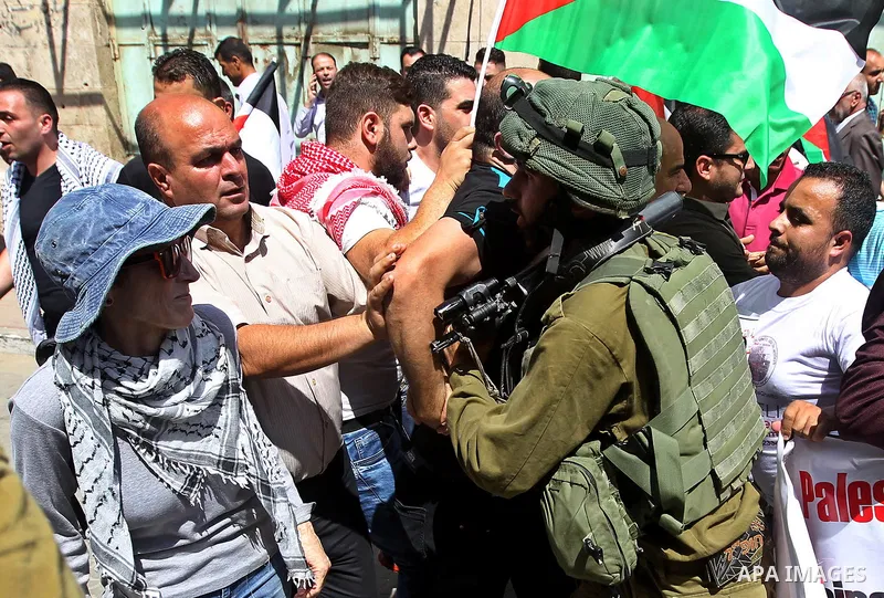 A Palestinian protester argues with an Israeli soldier during a demonstration in the West Bank city of Hebron on September 15, 2017. Israel has given Jewish settlement enclaves in the occupied West Bank city of Hebron th...