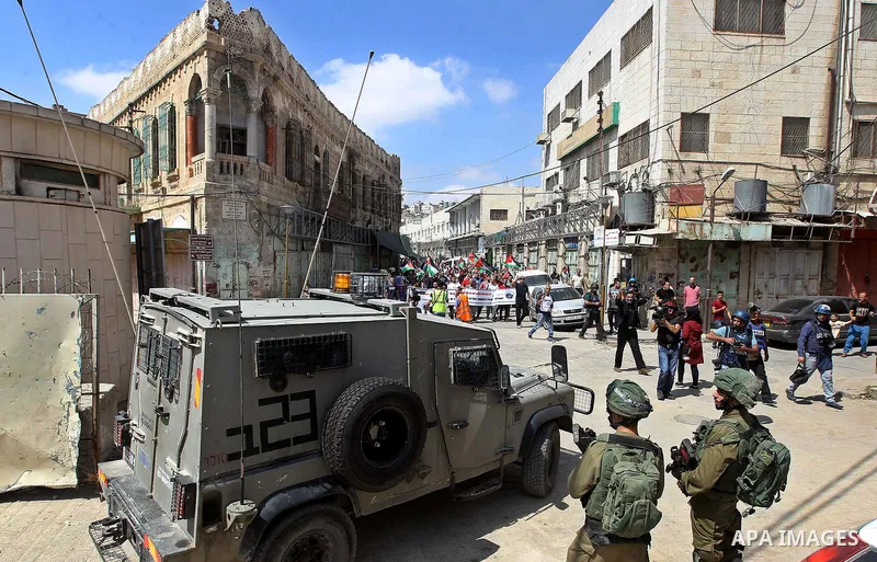Israeli soldiers stand guard in the middle of the main street during a demonstration in the West Bank city of Hebron on September 15, 2017. Israel has given Jewish settlement enclaves in the occupied West Bank city of He...