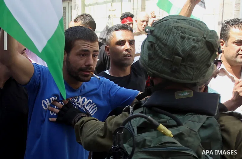 A Palestinian protester argues with an Israeli soldier during a demonstration in the West Bank city of Hebron on September 15, 2017. Israel has given Jewish settlement enclaves in the occupied West Bank city of Hebron th...