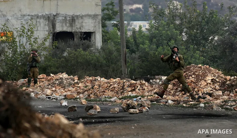 Israeli security forces take position during clashes with Palestinian protesters following demonstration against the expropriation of Palestinian land by Israel in the village of Kfar Qaddum, near Nablus in the occupied...