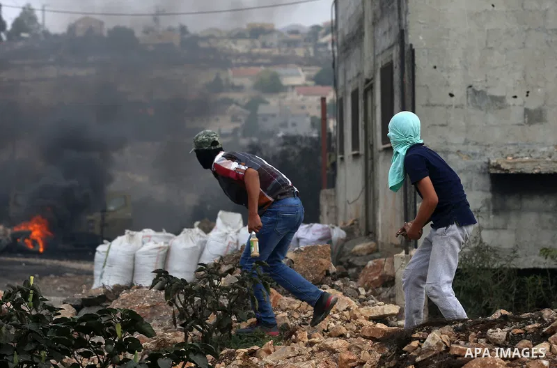 Palestinian protesters hurl stones towards Israeli security forces during clashes following demonstration against the expropriation of Palestinian land by Israel in the village of Kfar Qaddum, near Nablus in the occupied...