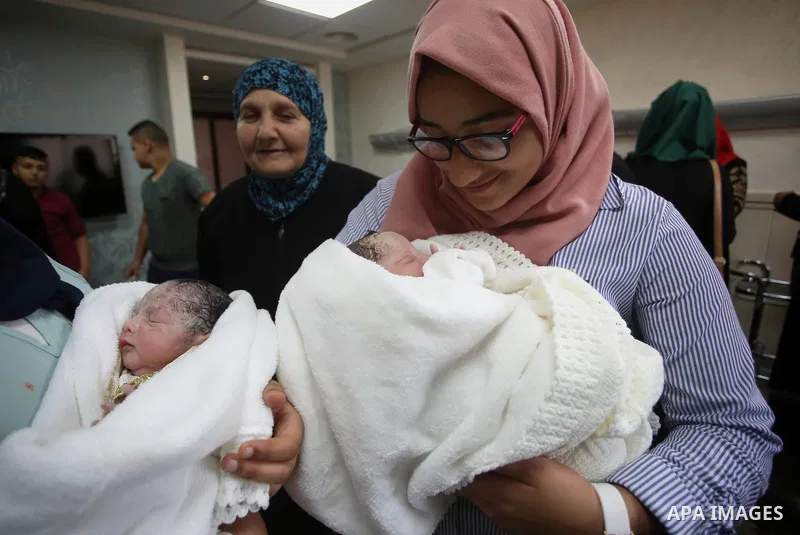 The daughter of Palestinian prisoner Qasim al-Akeleek, 34, holds one of twins who were conceived with sperm from her father smuggled out of an Israeli prison at Arab Specialist Hospital in the West Bank city of Nablus on...