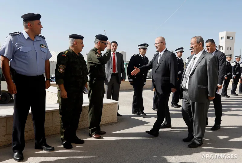 Palestinian Prime Minister Rami Hamdallah arrives before a meeting with Palestinian security chiefs in the West Bank city of Hebron on September 18, 2017. Photo by Wisam Hashlamoun