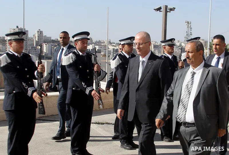 Palestinian Prime Minister Rami Hamdallah arrives before a meeting with Palestinian security chiefs in the West Bank city of Hebron on September 18, 2017. Photo by Wisam Hashlamoun