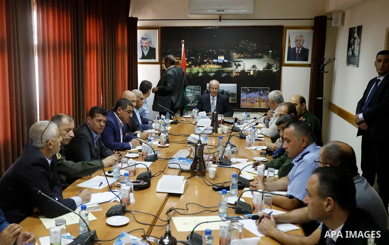 Palestinian Prime Minister Rami Hamdallah meets with Palestinian security chiefs in the West Bank city of Hebron on September 18, 2017. Photo by Wisam Hashlamoun