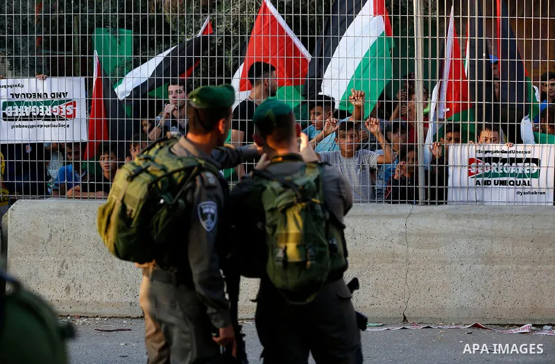 Israeli security forces take photos to Palestinian protesters during a demonstration in the West Bank city of Hebron on September 18, 2017. Israel has given Jewish settlement enclaves in the occupied West Bank city of He...