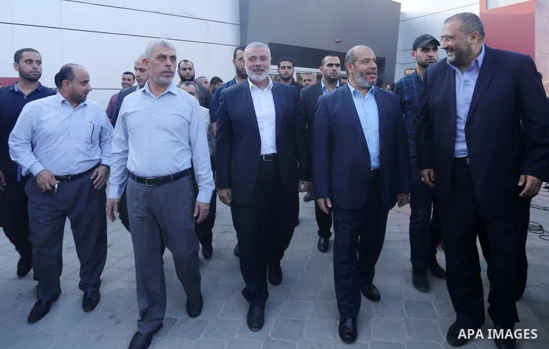 Hamas Gaza Chief Yahya Al-Sinwar, Hamas Chief Ismail Haniyeh and senior Hamas leader Khalil al-Hayya arrive on the Palestinian side of the Rafah border crossing, in the southern Gaza Strip on September 19, 2017. Haniyeh...