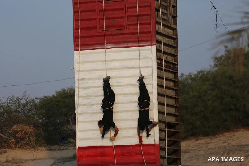 Palestinian militants of al-Nasser Salah al-Deen Brigades, the military wing of the Popular Resistance Committees, take part in a training exercise in Khan Younis in the southern Gaza Strip on September 19, 2017. Photo b...
