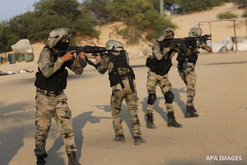 Palestinian militants of al-Nasser Salah al-Deen Brigades, the military wing of the Popular Resistance Committees, take part in a training exercise in Khan Younis in the southern Gaza Strip on September 19, 2017. Photo b...