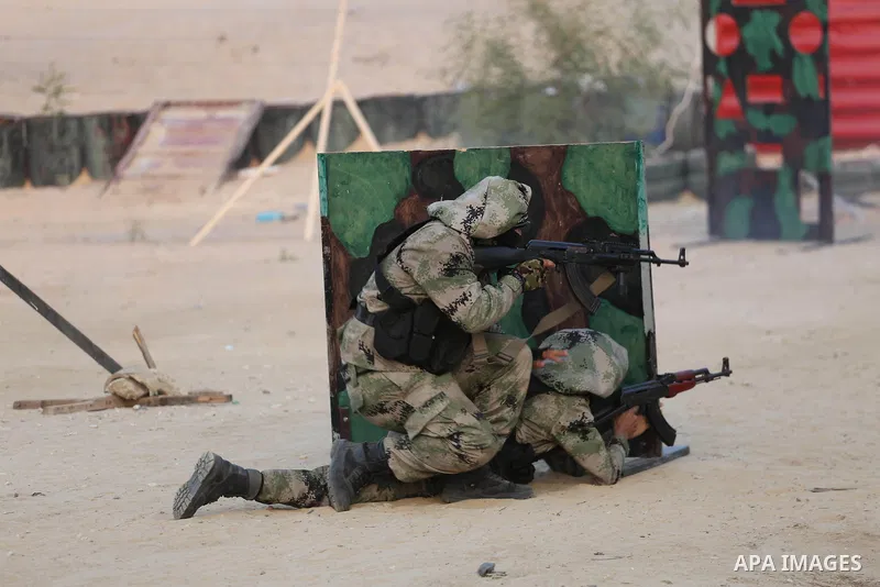 Palestinian militants of al-Nasser Salah al-Deen Brigades, the military wing of the Popular Resistance Committees, take part in a training exercise in Khan Younis in the southern Gaza Strip on September 19, 2017. Photo b...