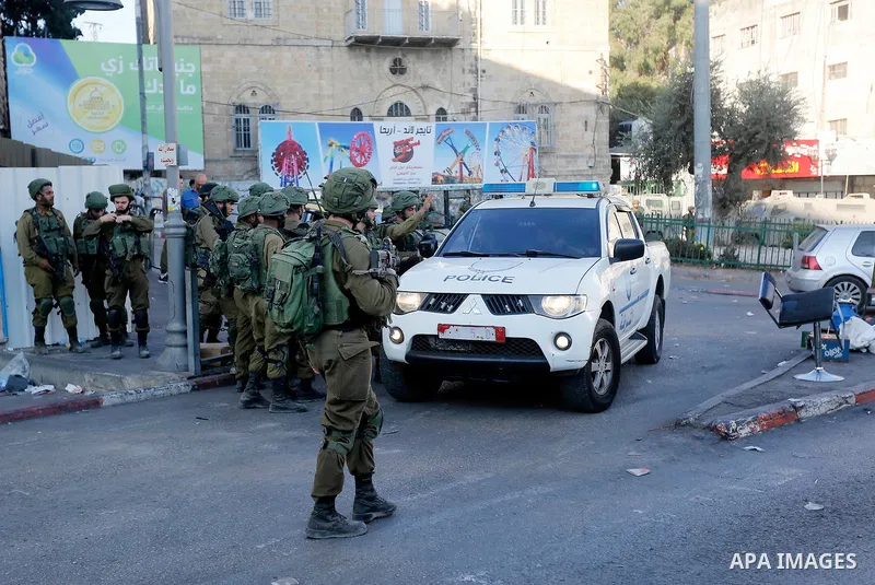 Israeli security forces take position after soldiers entered an area controlled by the Palestinian authority in the divided city of Hebron, in the Israeli-occupied West Bank, on September 20, 2017. Photo by Wisam Hashlam...