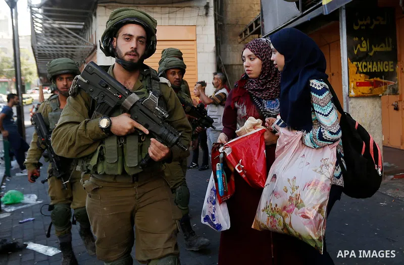 Israeli security forces take position after soldiers entered an area controlled by the Palestinian authority in the divided city of Hebron, in the Israeli-occupied West Bank, on September 20, 2017. Photo by Wisam Hashlam...