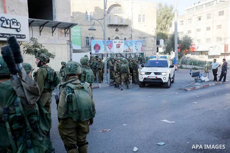 Israeli security forces take position after soldiers entered an area controlled by the Palestinian authority in the divided city of Hebron, in the Israeli-occupied West Bank, on September 20, 2017. Photo by Wisam Hashlam...