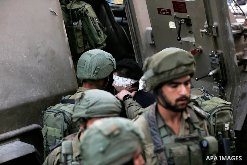 Israeli security forces detain a Palestinian youth after soldiers entered an area controlled by the Palestinian authority in the divided city of Hebron, in the Israeli-occupied West Bank, on September 20, 2017. Photo by...