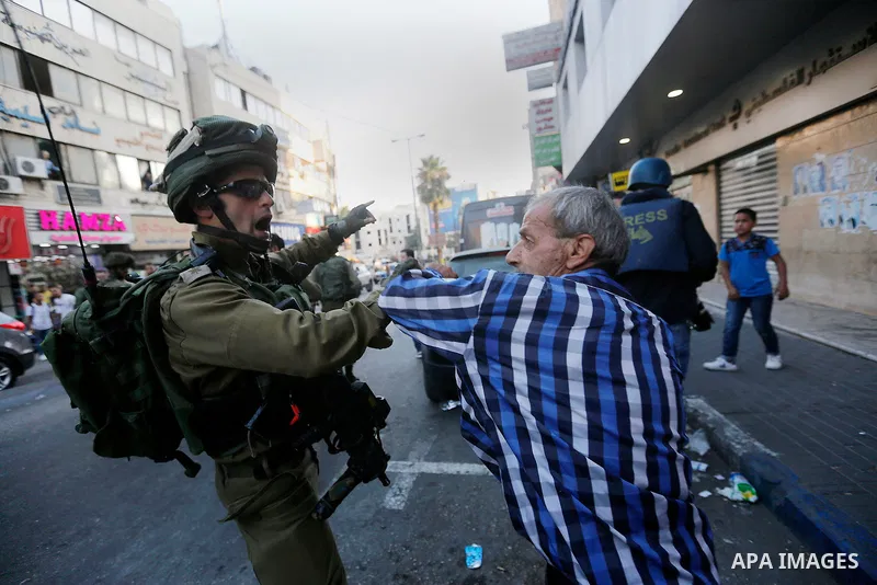 A Palestinian man argues with Israeli security forces after soldiers entered an area controlled by the Palestinian authority in the divided city of Hebron, in the Israeli-occupied West Bank, on September 20, 2017. Photo...