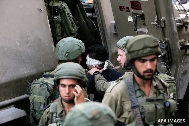 Israeli security forces detain a Palestinian youth after soldiers entered an area controlled by the Palestinian authority in the divided city of Hebron, in the Israeli-occupied West Bank, on September 20, 2017. Photo by...