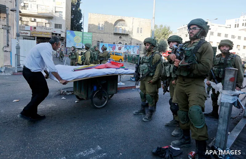 Israeli security forces take position after soldiers entered an area controlled by the Palestinian authority in the divided city of Hebron, in the Israeli-occupied West Bank, on September 20, 2017. Photo by Wisam Hashlam...