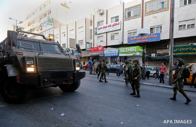 Israeli security forces take position after soldiers entered an area controlled by the Palestinian authority in the divided city of Hebron, in the Israeli-occupied West Bank, on September 20, 2017. Photo by Wisam Hashlam...